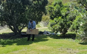 Police conduct the investigation at the Mangere Bridge reserve.