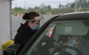 A driver is vaccinated on the first day of the country's largest drive-through vaccination centre at the Park and Ride at Auckland Airport
