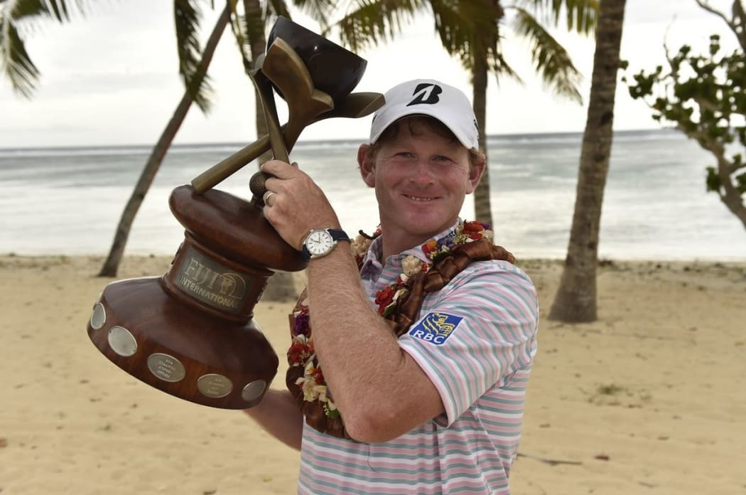 Brandt Snedeker on the beach with the Fiji International trophy.