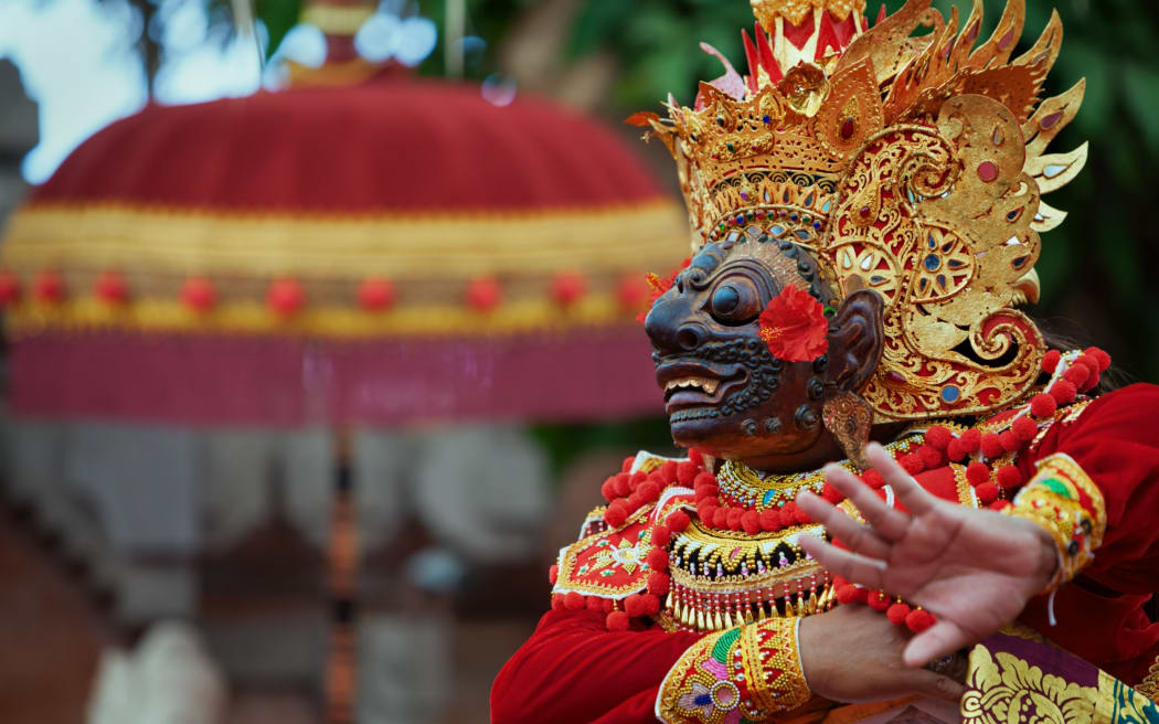 A person wearing traditional Balinese costume.