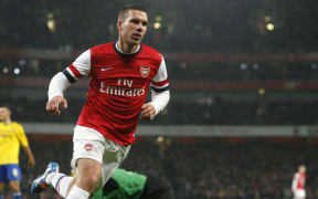 German forward Lukas Podolski scores for Arsenal.