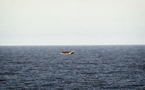 A rubber boat with migrants is seen off the Libya coast in May.