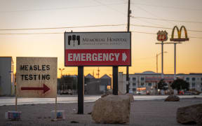 Signs point the way to measles testing in the parking lot of the Seminole Hospital District across from Wigwam Stadium on 27 February, 2025 in Seminole, Texas.