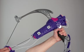 Dylan uses a Nerf bow as a contoller while playing Overwatch.