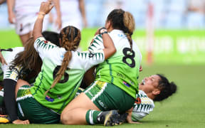 Cook Islands players celebrate Te Amohaere Ngata-Aerengamate's winning try.
