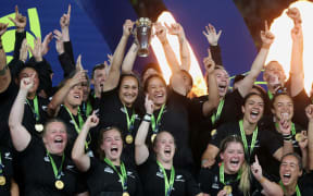 New Zealand's players lift the trophy after winning the Rugby World Cup final match between New Zealand and England at Eden Park in Auckland.