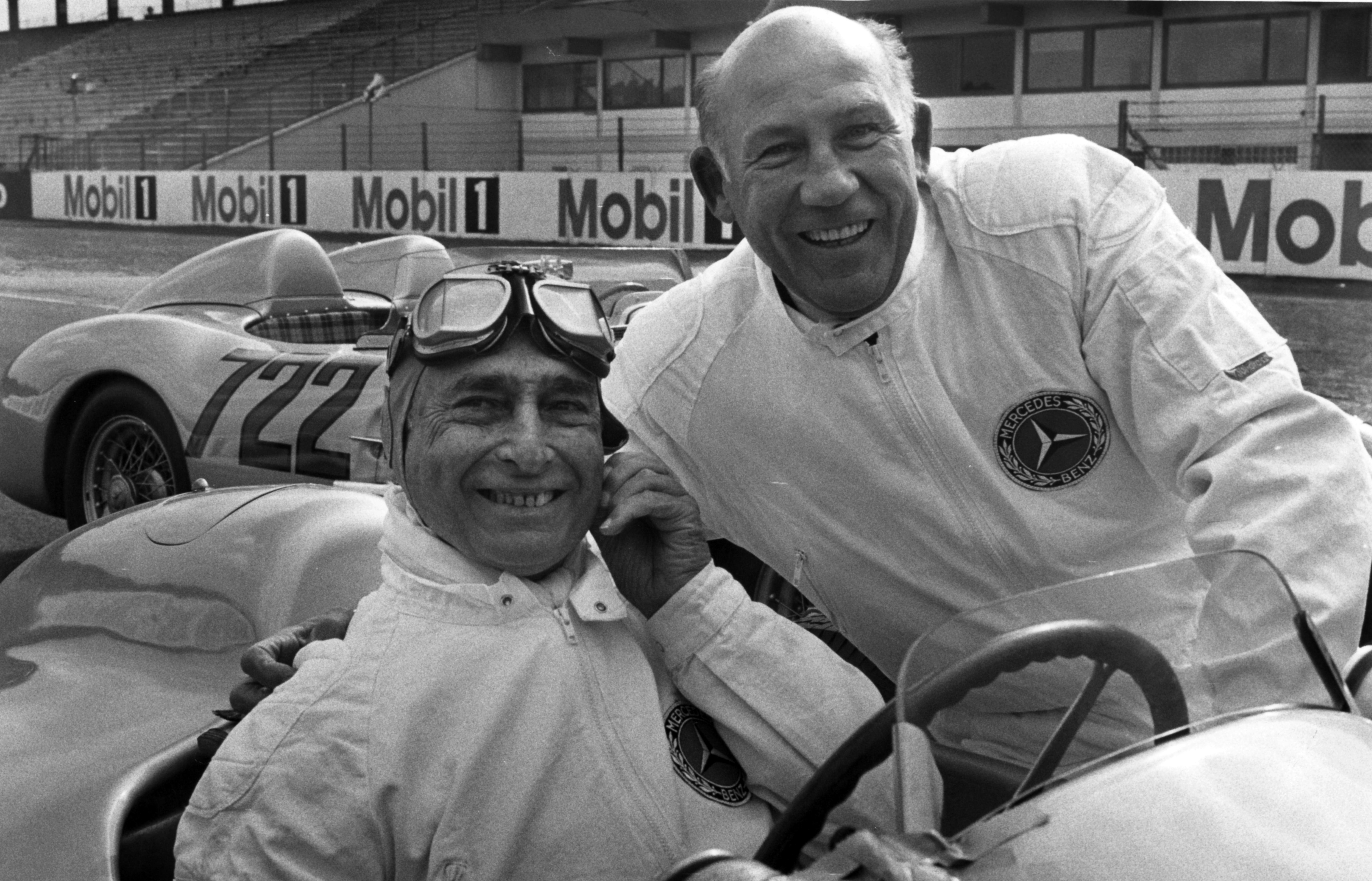 Former British racing driver Stirling Moss (r) and his former competitor Juan Manuel Fangio from Argentina pose together on April 24, 1991.