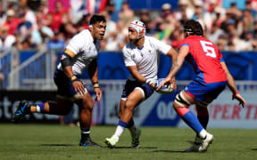 Christian Leali'ifano of Samoa runs with the ball whilst under pressure from Santiago Pedrero of Chile during the Rugby World Cup France 2023 match between Samoa and Chile at Nouveau Stade de Bordeaux on September 16, 2023 in Bordeaux, France. (Photo by Adam Pretty - World Rugby/World Rugby via Getty Images)