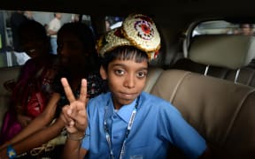 Indian chess prodigy Rameshbabu Praggnanandhaa, poses for a photograph on his arrival at an airport in Chennai after becoming the world's second youngest chess grandmaster ever in 2018.