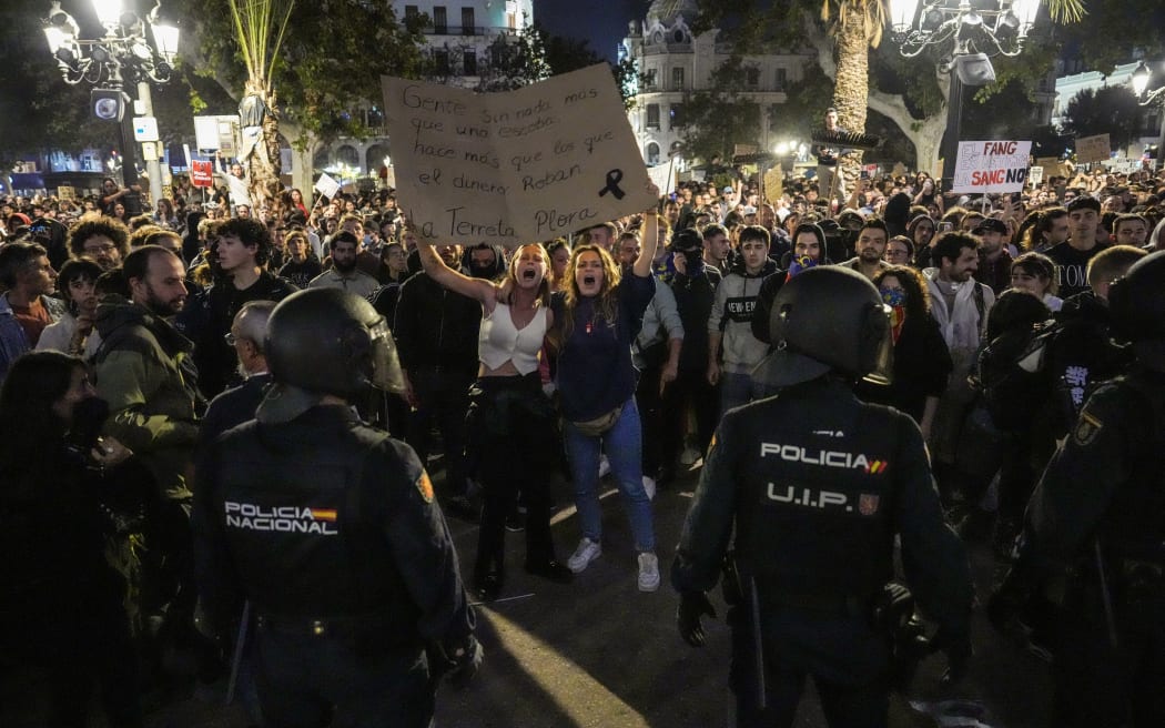 Protesters hold up a banner during a demonstration to demand the resignation of Valencia Regional President Carlos Mazon in Valencia on November 9, 2024. - The European nation's worst floods in a generation have killed at least 220 people, left dozens missing and submerged entire towns in mud, particularly in the eastern Valencia region. (Photo by Cesar Manso / AFP)