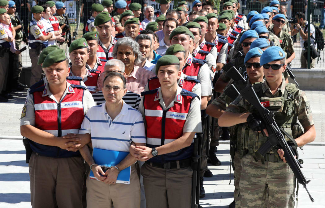 Defendants arrive at court for their trial, being held at Akinci airbase outside of Ankara