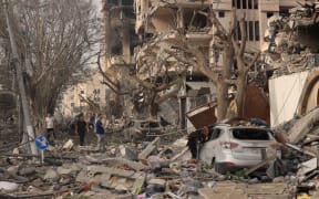 Palestinians inspect the massive destruction from Israeli airstrikes in Gaza City, on October 10, 2023. Israel kept up its deadly bombardment of Hamas-controlled Gaza on October 10 after the Palestinian militant group threatened to execute some of the around 150 hostages it abducted in a weekend assault if air strikes continue without warning. (Photo by MAHMUD HAMS / AFP)