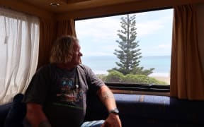 Mark Wills, who is organizing a petition against a proposed quad bike ban in Marlborough, looks out the window of his campervan at Marfells Beach.