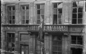 New Zealand flag handing outside Le Quesnoy's war-damaged town hall in 1918
