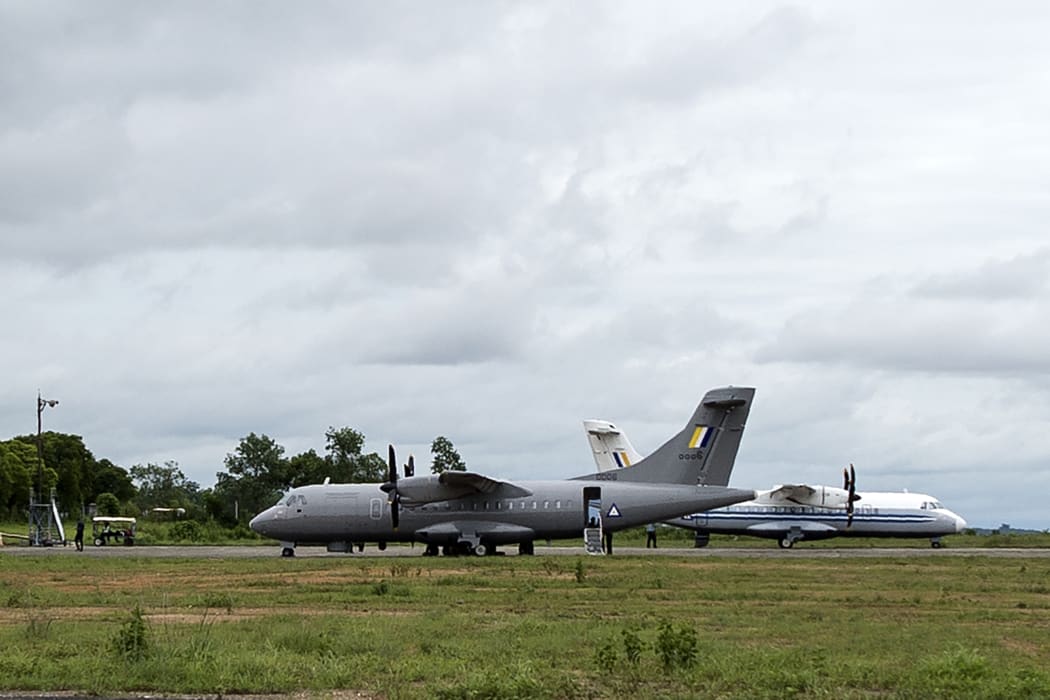A Myanmar Air Force plane (L) is pictured at Dawei Airport on 8 June 2017, the day after a military plane disappeared off the coast of Launglon, in southern Myanmar