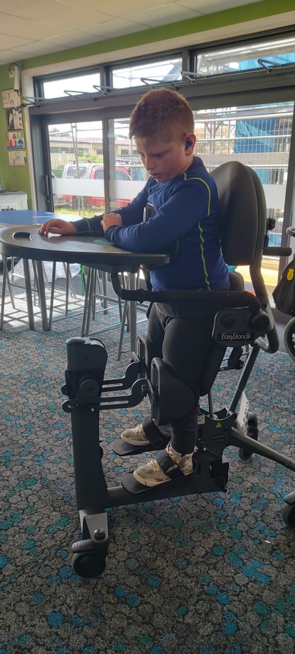 11-year-old Alex has waited nearly a year for specialist equipment to allow him to stand upright.