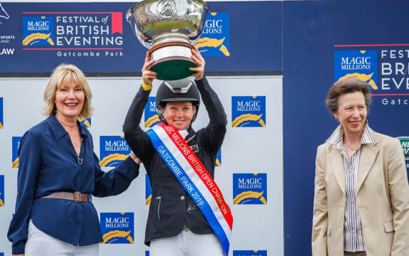 Jonelle Price lifts the British Open Championship trophy.