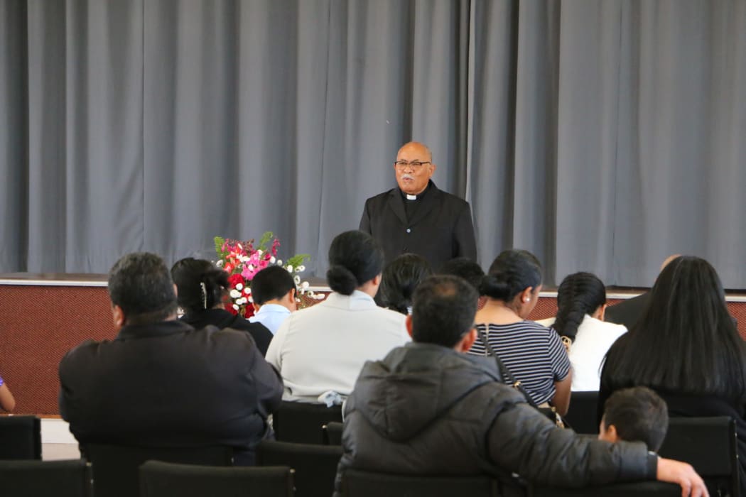 Reverend Paula Pouno Fonua holds a relocated service for the Free Church of Tonga in the Levin Memorial Hall as they await renovation to begin on their own building.