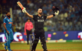 Daryl Mitchell celebrates a century against India in their World Cup semi-final in Mumbai.