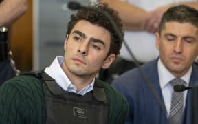 Luigi Mangione, accused killer of US insurance CEO Brian Thompson, sits in Manhattan Supreme Court as he attends a hearing in New York City on February 21, 2025. Mangione is accused of gunning down Thompson in a brazen hit in New York on December 4, 2024, pleaded not guilty to state charges including "terrorist" murder. The suspect is charged in both state and federal court. (Photo by Steven HIRSCH / POOL / AFP)