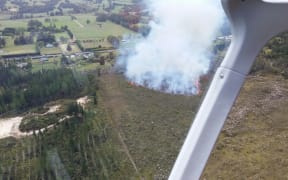 Ten homes were evacuated as fire raged through dry scrub near a pine forest just west of Ngawha in Northland on 13 December 2015.