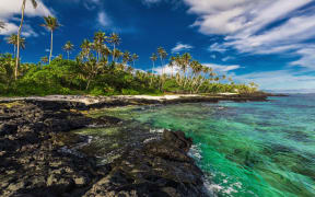 Beach with coral reef and black volcanic rocks on south side of Upolu, Samoa Islands