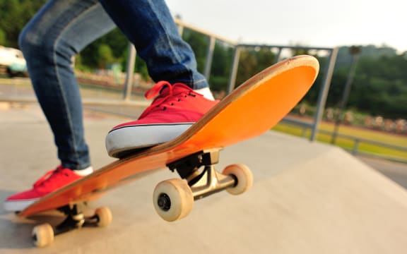 A person skateboarding at a skate park.