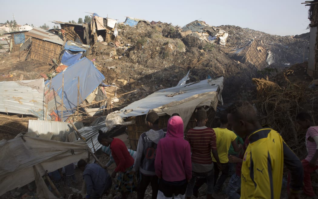 Rescuers try to free trapped people from the rubble.