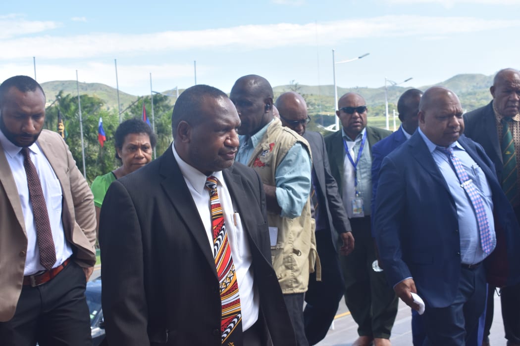 The new prime minister of Papua New Guinea, Jame Marape (In foreground wearing coloured necktie), surrounded by his supporters on the steps of the PNG parliament.