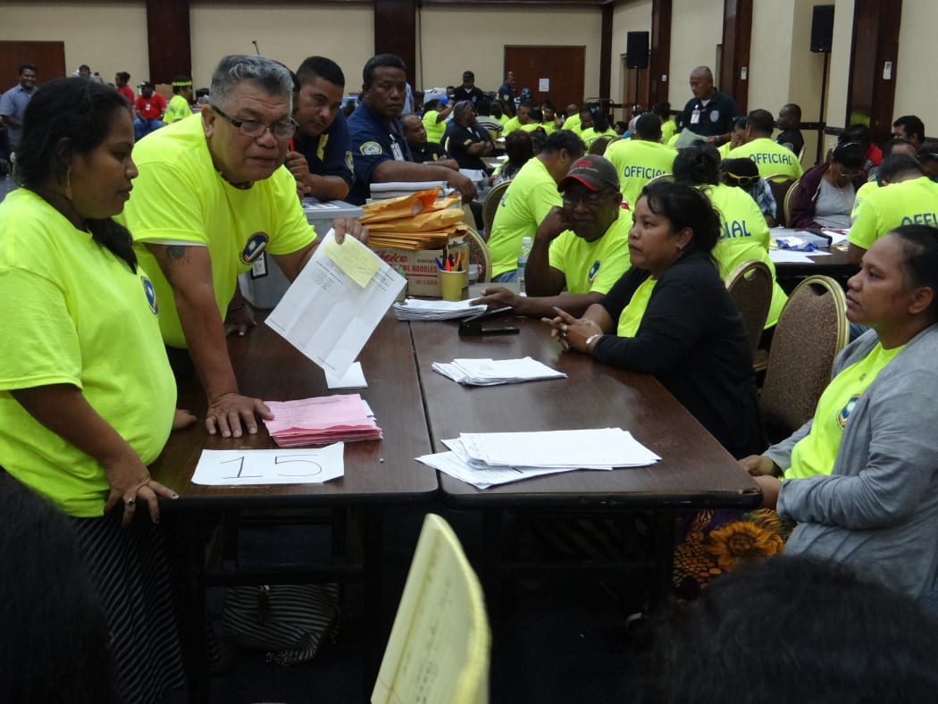 Marshall Islands Chief Electoral Officer Robson Almen (holding paper) talks to tabulators during the late November ballot counting in Majuro in 2015.