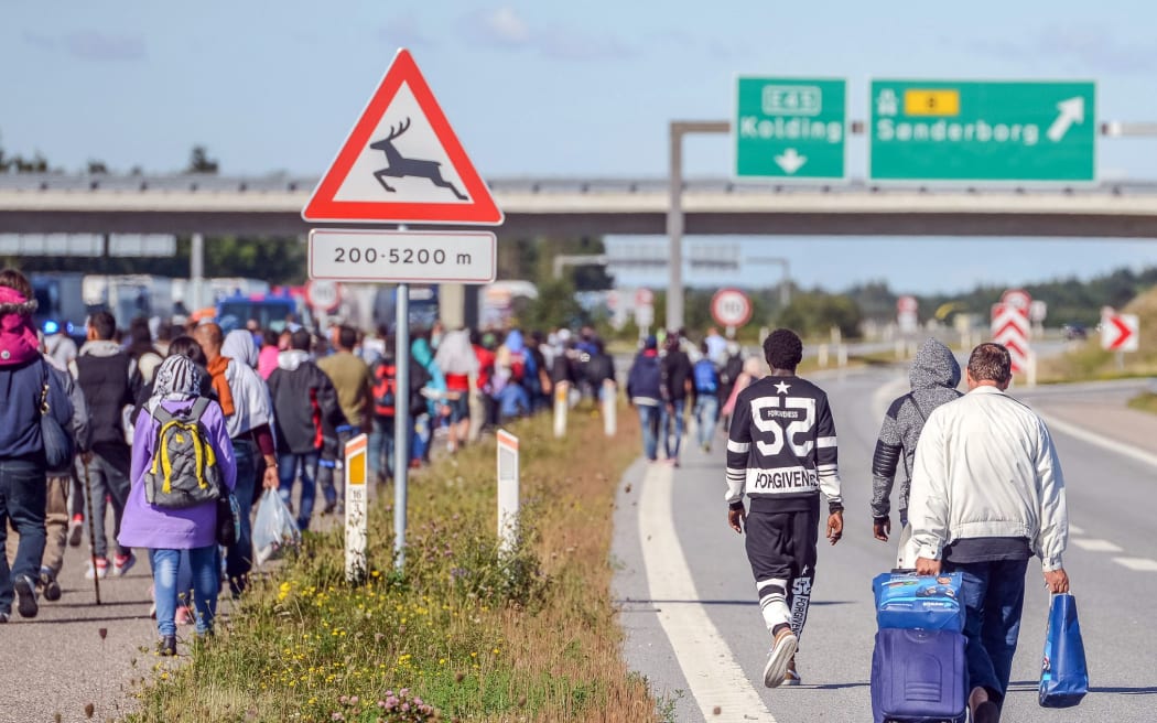 Refugees walking north along the Danish E45 motorway.