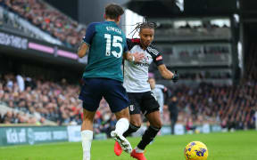 31st December 2023; Craven Cottage, Fulham, London, England; Premier League Football, Fulham versus Arsenal; Bobby De Cordova-Reid of Fulham is defended by Jakub Kiwior of Arsenal.