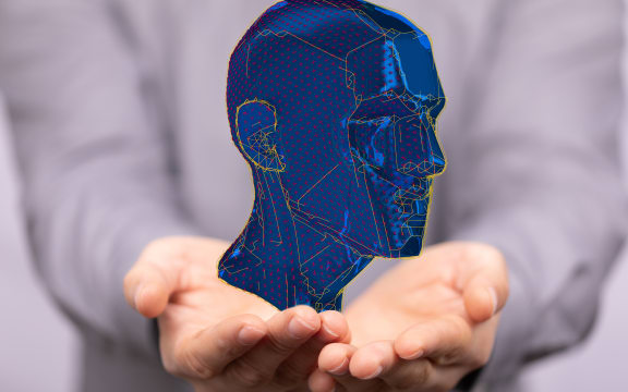 A digital concept of artificial intelligence with a human head on a hand.