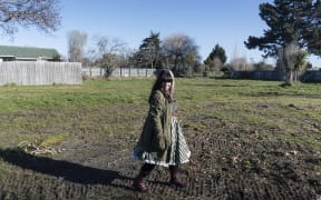 Louise Sutherland stands on the land where her house once was.