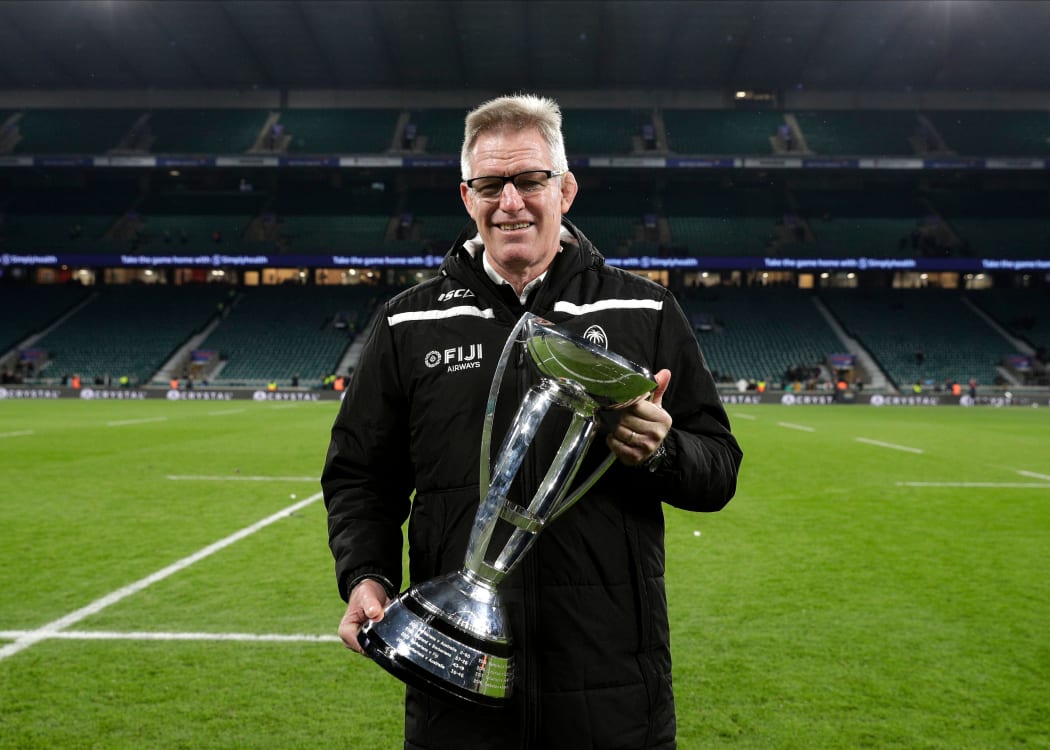 Fiji coach John McKee holds the Killik Cup after beating the Barbarians.