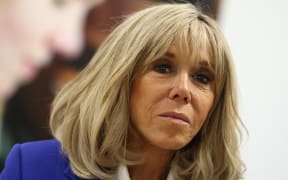 Brigitte Macron, wife of France's President, listens to explanations as she visits the "MIND Us" foundation, working to improve the mental health of young people, in Amsterdam on April 12, 2023, as part of a two-day official trip in the Netherlands. (Photo by KENZO TRIBOUILLARD / AFP)