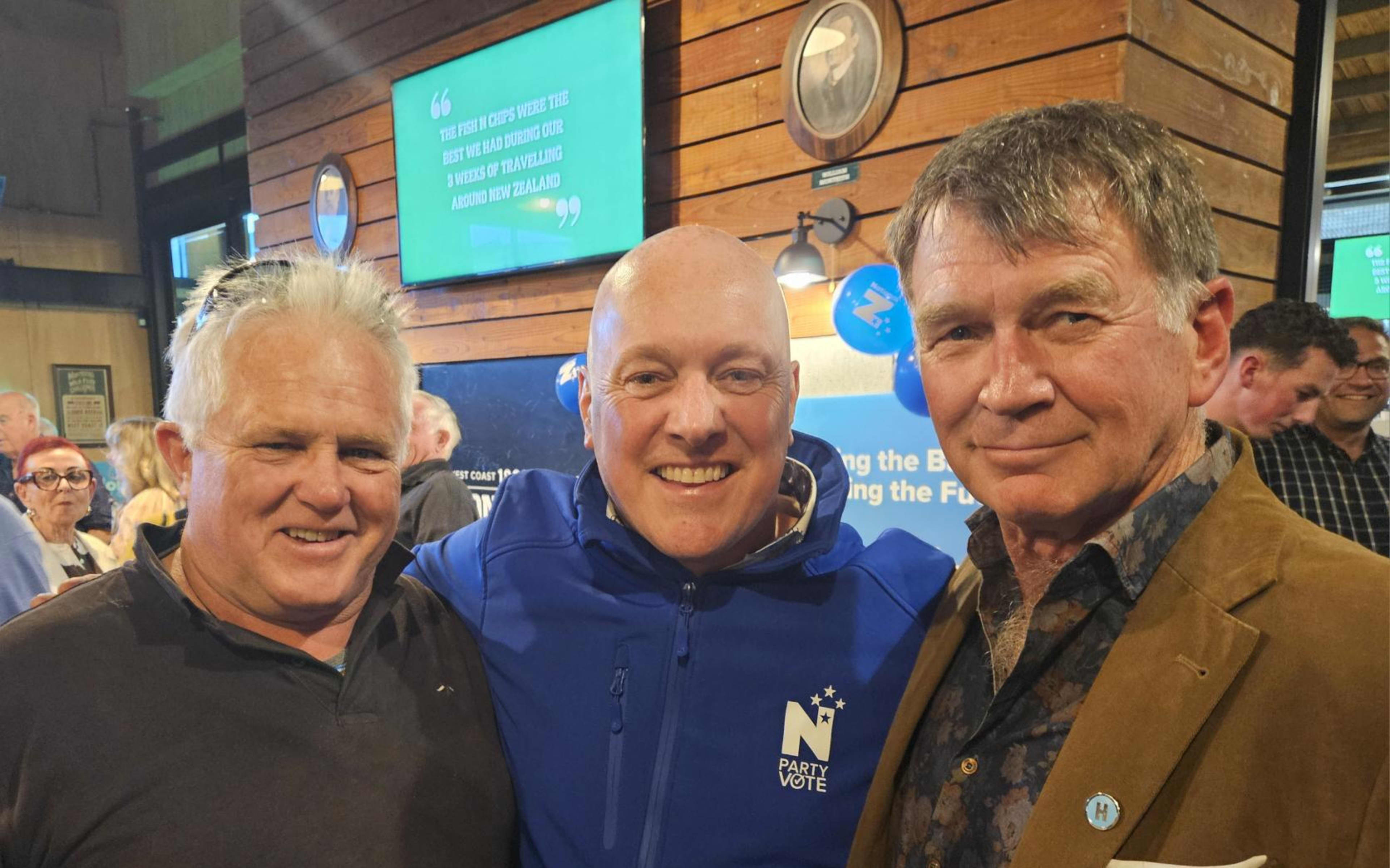 National leader Christopher Luxon is flanked by Brett Cummings (left) and Geoff Ball at Thursday's West Coast rally