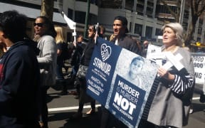 Protesters march to Parliament to deliver a petition calling for an end to plea bargaining.