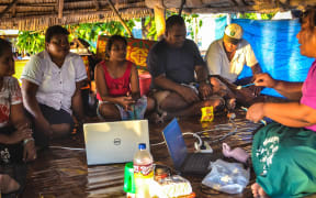 Lab technologists in Kiribati training nurses on an outer island to perform pap smear tests.
