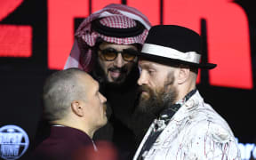 Ukraine's Oleksandr Usyk and Britain's Tyson Fury face off during a press conference ahead of their undisputed heavyweight world championship rematch, in Riyadh on 20 December 2024.