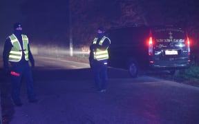 PRZEWODOW, POLAND - NOVEMBER 16: Police officers secure access to the site of the explosion in the village of Przewodow in the Lublin Voivodeship, on November 16, 2022 in Przewodow, Poland. At least two people were killed Tuesday in a suspected missile attack in eastern Poland not far from the Ukrainian border. Artur Widak / Anadolu Agency (Photo by Artur Widak / ANADOLU AGENCY / Anadolu Agency via AFP)