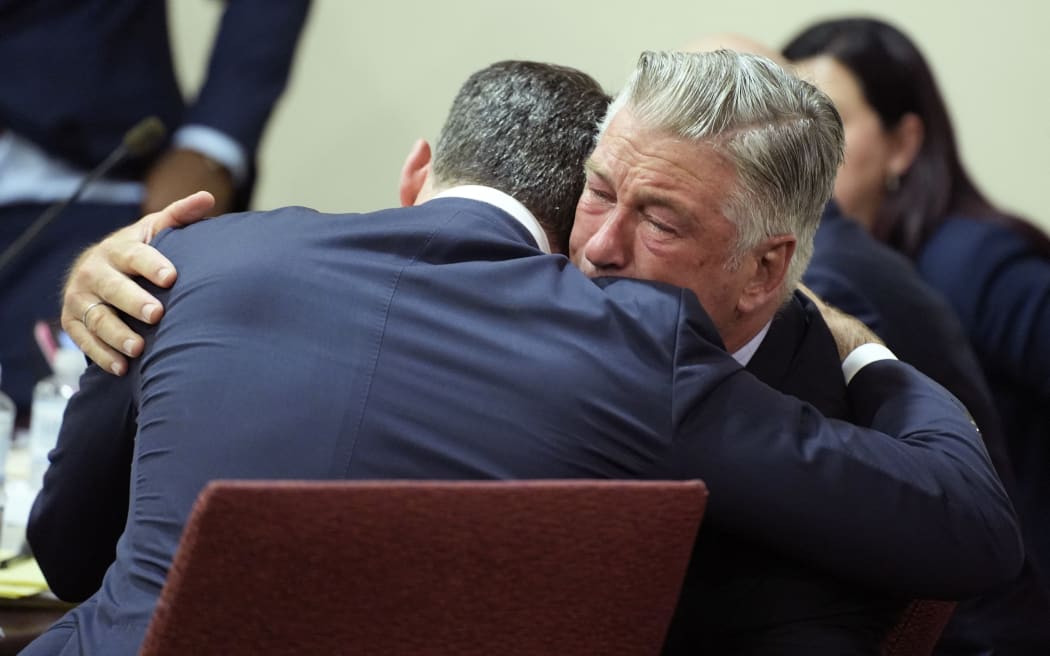 SANTA FE, NEW MEXICO - JULY 12: Alec Baldwin hugs his attorney Alex Spiro at the conclusion of his trial for involuntary manslaughter in First Judicial District Court on July 12, 2024 in Santa Fe, New Mexico. The trial for involuntary manslaughter was dismissed by a judge Friday after she ruled that key evidence over a fatal shooting on the set of "Rust" had been withheld from the defense.   Ramsay de Give-Pool/Getty Images/AFP (Photo by POOL / GETTY IMAGES NORTH AMERICA / Getty Images via AFP)
