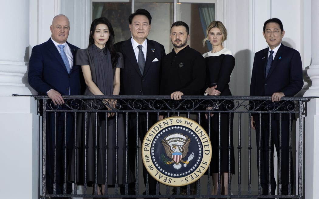 (From left) New Zealand Prime Minister Christopher Luxon, Kim Keon See and her husband South Korean President Yoon Suk Yeol, Ukraine President Volodymyr Zelenskyy and his wife Olena Zelenska and Japanese Prime Minister Fumio Kishida watch from the balcony while participating in a group photo with NATO allies and partners at the White House on July 10, 2024 in Washington, DC. The President and first lady are hosting the NATO members and their spouses for an official dinner in the East Room of the White House.