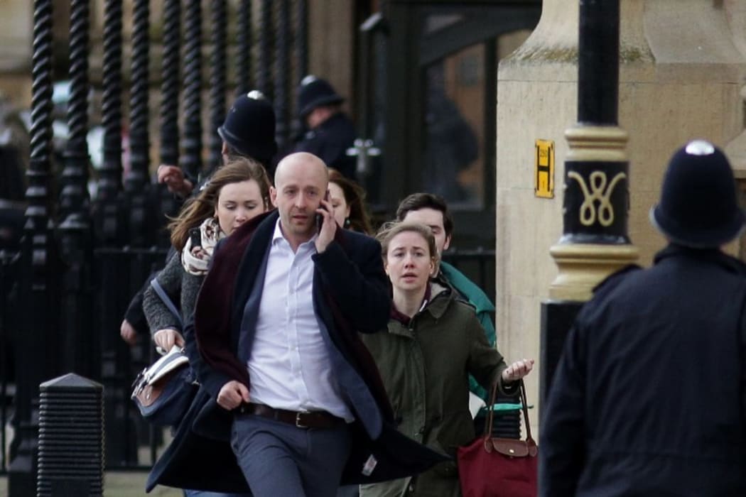People are evacuated from the Houses of Parliament in central London after an attacker mowed down pedestrians and stabbed a police officer to death.