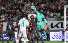 New Zealand's Michael Boxall scores for New Zealand against New Caledonia goalkeeper Rocky Nyikeine.