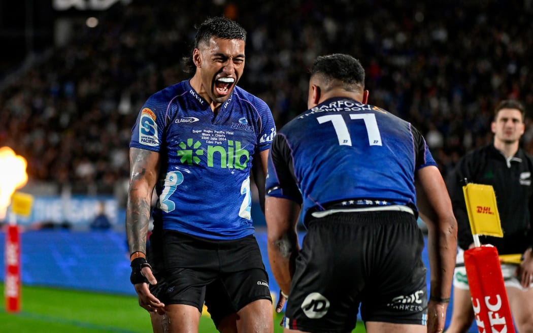 Rieko Ioane celebrates a try by Caleb Clarke in the Super Rugby Pacific final.