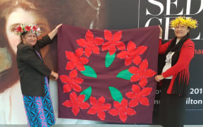 Two of the women with one of the tivaivai they made to commemorate their Cook Island ancestors who fought in World War One.