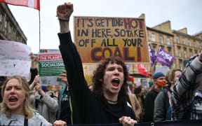 Youth activists shout as they march to protest against climate inaction on the sidelines of the COP26 UN Climate Summit in Glasgow on November 5, 2021.