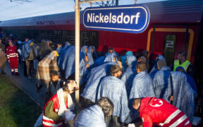 Migrants board a train in the Austrian village of Nickelsdorf, to head to Salzburg on the German-Austrian border.