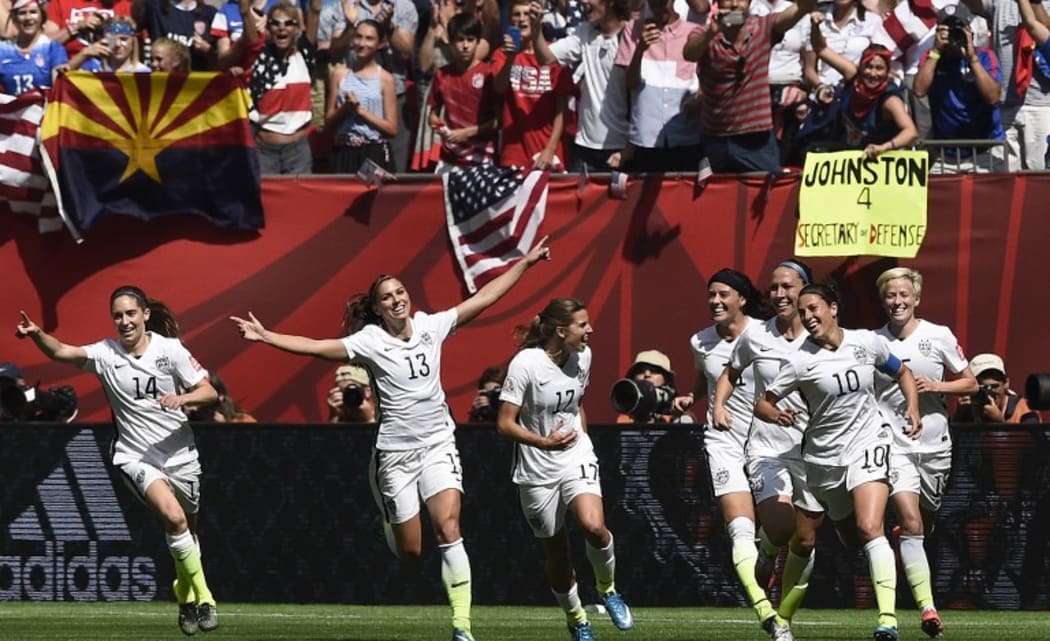 (FILES) In this file photo taken on July 05, 2015 USA midfielder Carli Lloyd (10) celebrates her goal with teammates during the final football match between USA and Japan during their 2015 FIFA Women's World Cup at the BC Place Stadium in Vancouver. )